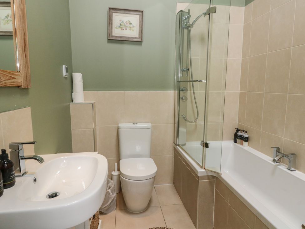 A bathroom with a toilet, sink and bathtub at Yew Tree in Killin