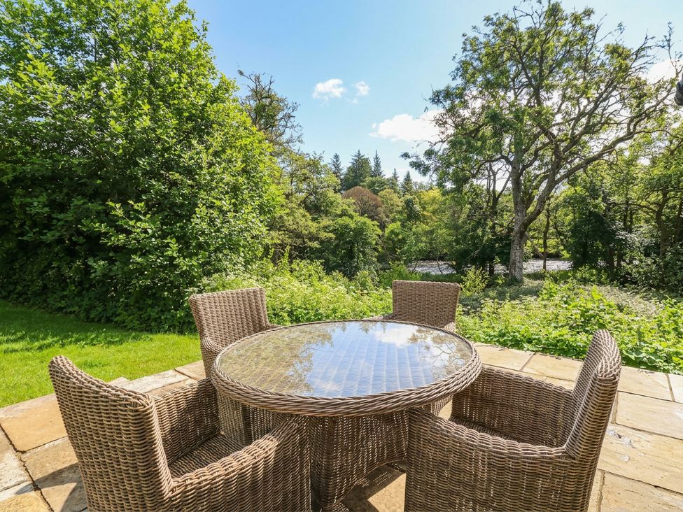 A garden with a table and chairs at Yew Tree in Killin