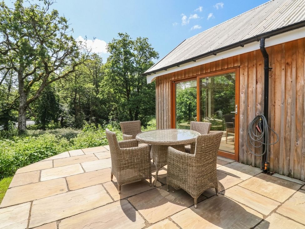 An outdoor patio with a table and chairs at Yew Tree in Killin