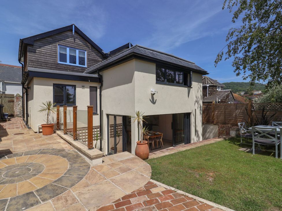 A house exterior with garden and outdoor dining table at Mayflower Cottage Lyme Regis