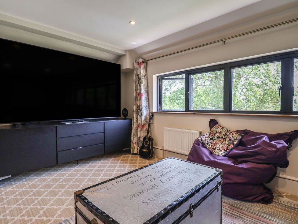 A snug with a television and a bean bag at Mayflower Cottage in Lyme Regis