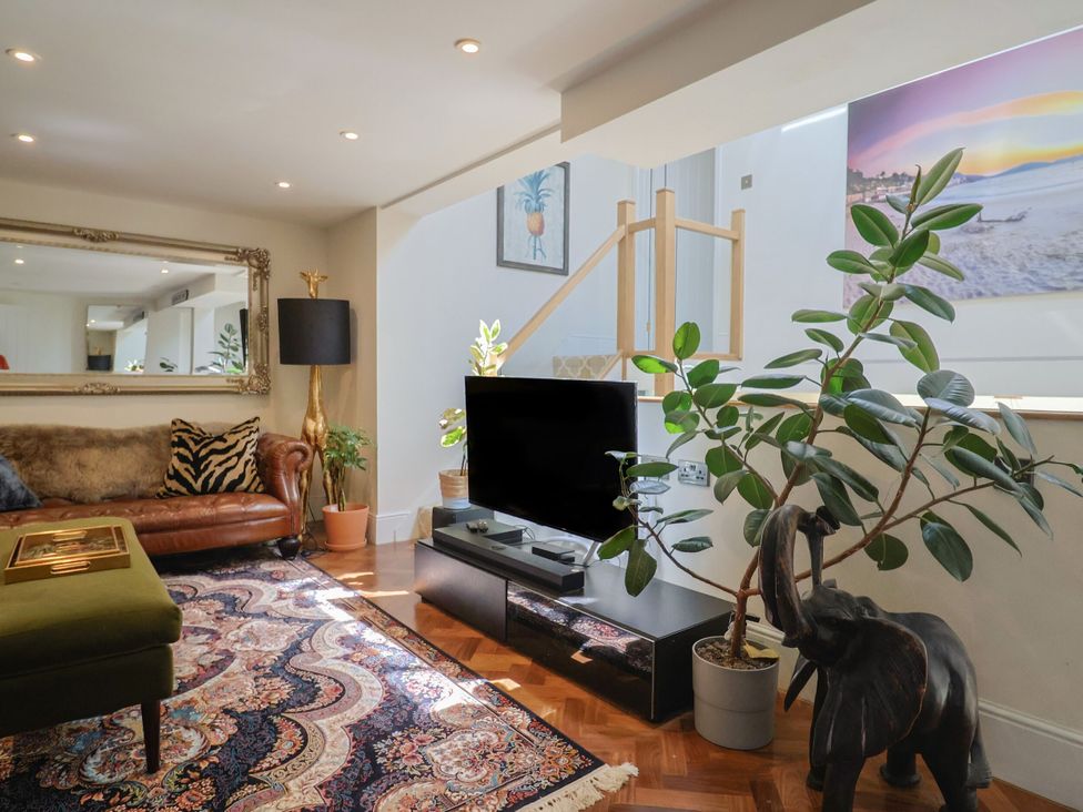 A living room with a sofa and coffee table at Mayflower Cottage in Lyme Regis