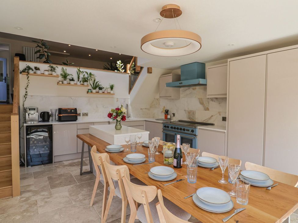 A kitchen with a dining table set at Mayflower Cottage in Lyme Regis