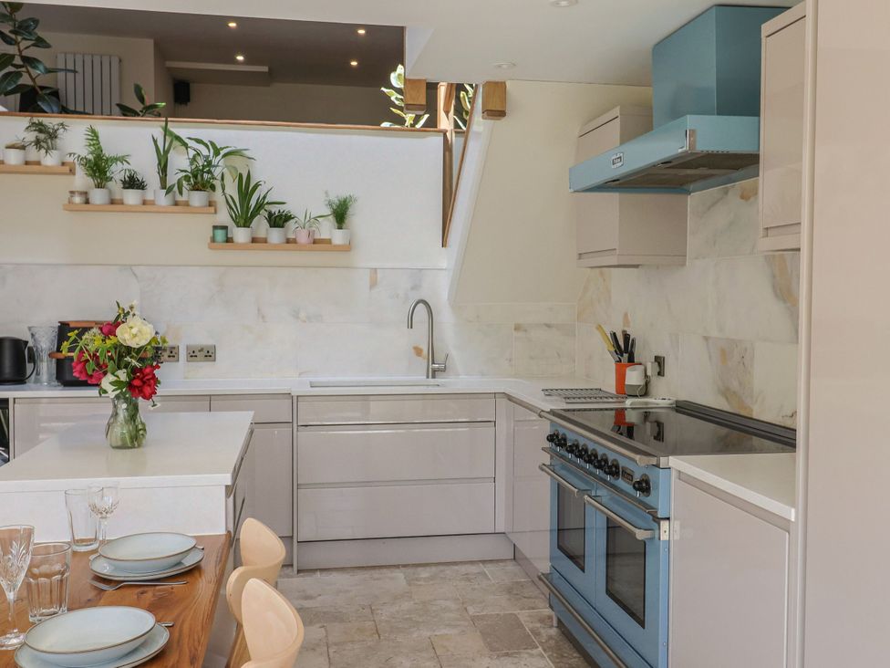 A kitchen with countertops and a stove at Mayflower Cottage in Lyme Regis