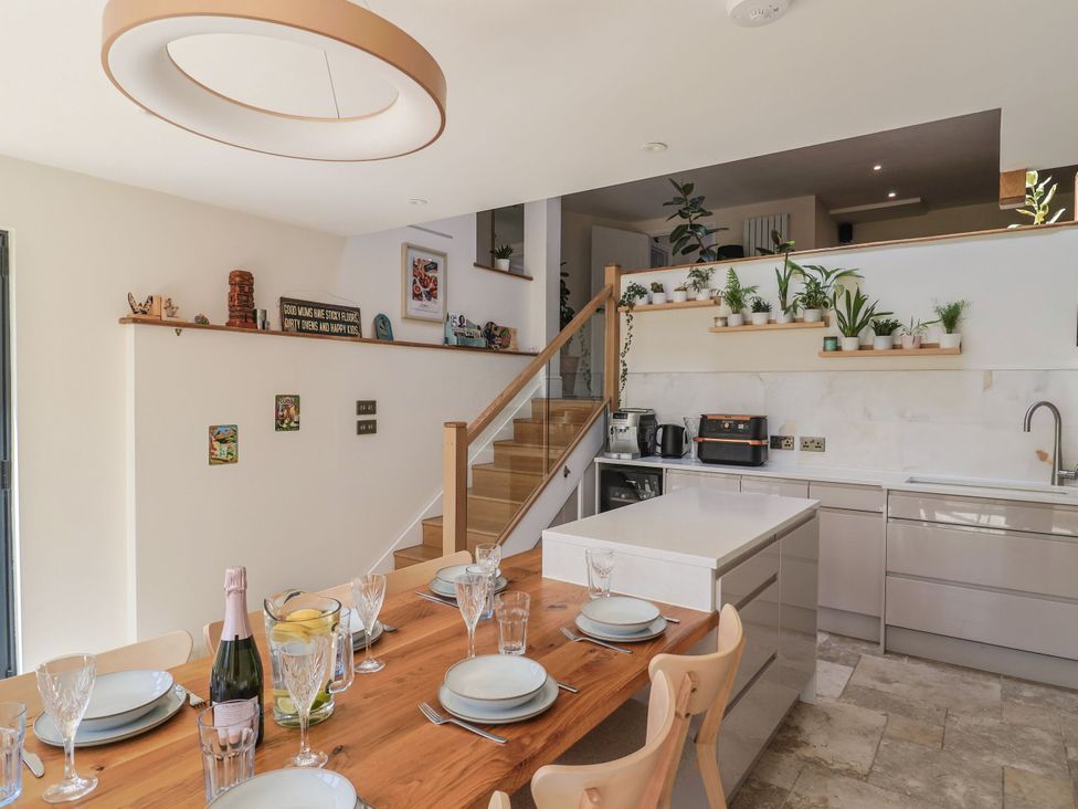 A kitchen with a dining table set for a meal at Mayflower Cottage in Lyme Regis