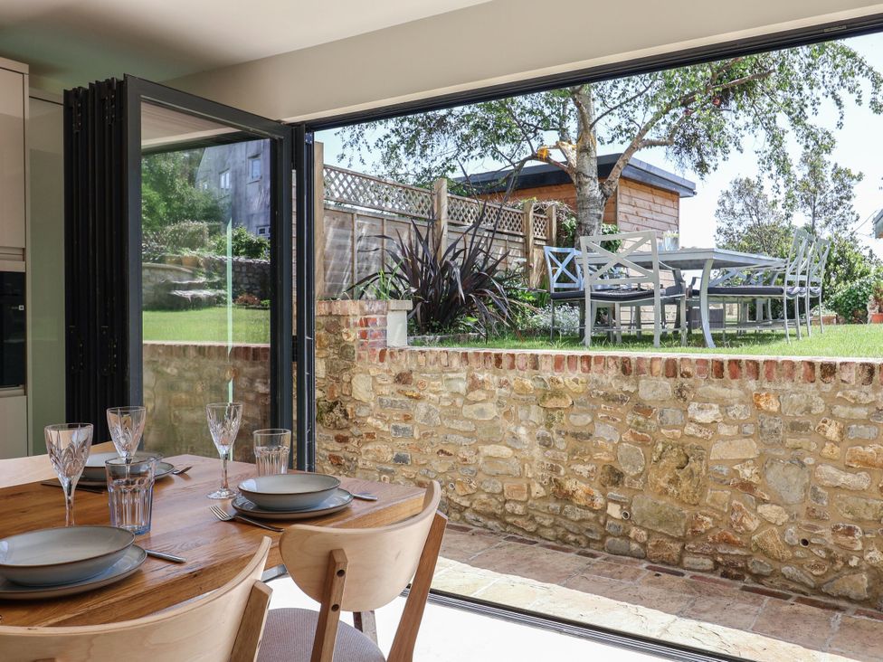 A dining area with a view of the garden at Mayflower Cottage in Lyme Regis