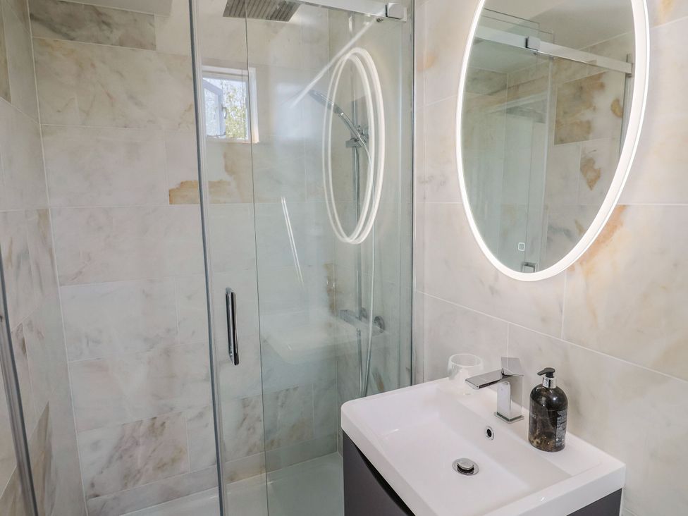 A bathroom with a shower and sink at Mayflower Cottage in Lyme Regis
