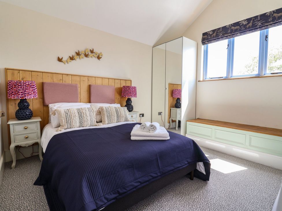 A bedroom with a bed and side tables at Mayflower Cottage in Lyme Regis