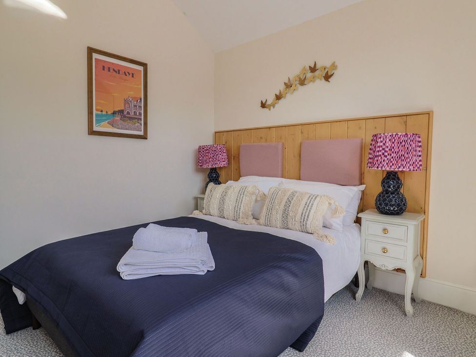 A bedroom with a bed and bedside tables at Mayflower Cottage in Lyme Regis