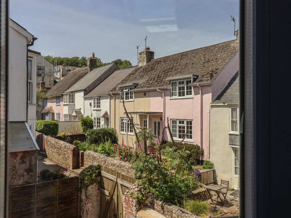 A view of houses with gardens and pathway at Mayflower Cottage in Lyme Regis