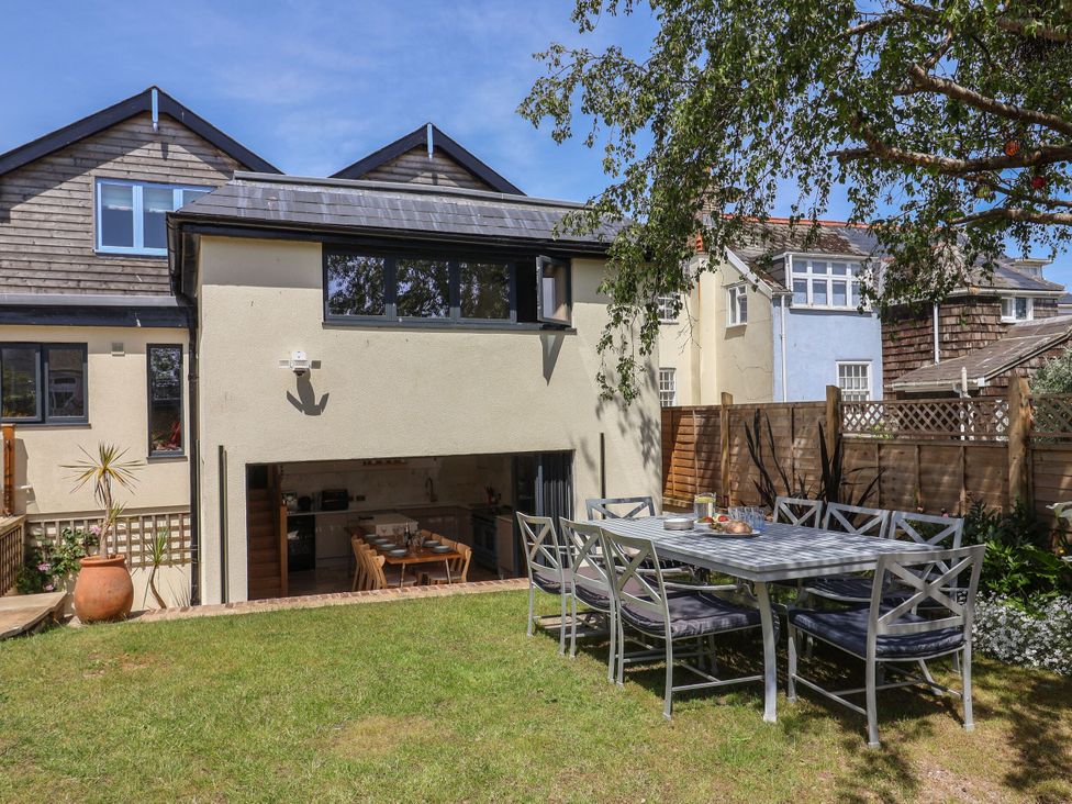 A garden with a dining table and chairs at Mayflower Cottage in Lyme Regis