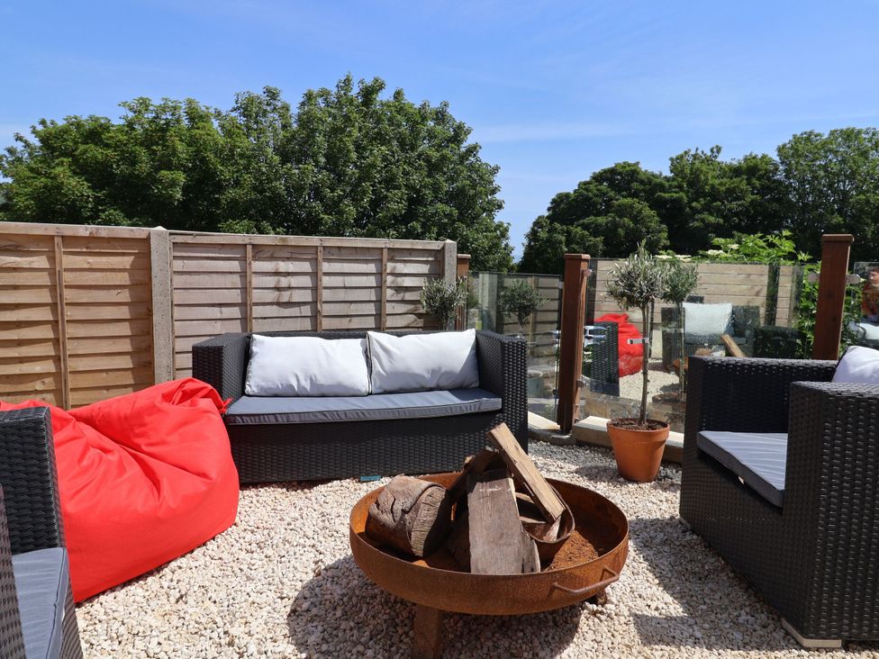 An outdoor seating area with a fire pit and gravel at Mayflower Cottage in Lyme Regis