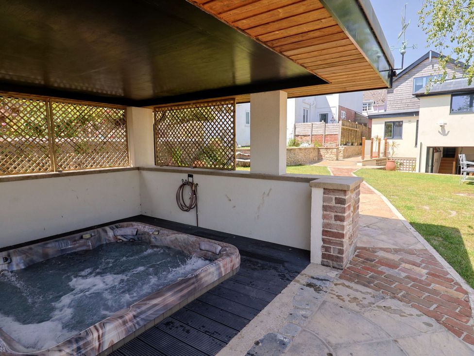 A hot tub in an outdoor area at Mayflower Cottage in Lyme Regis