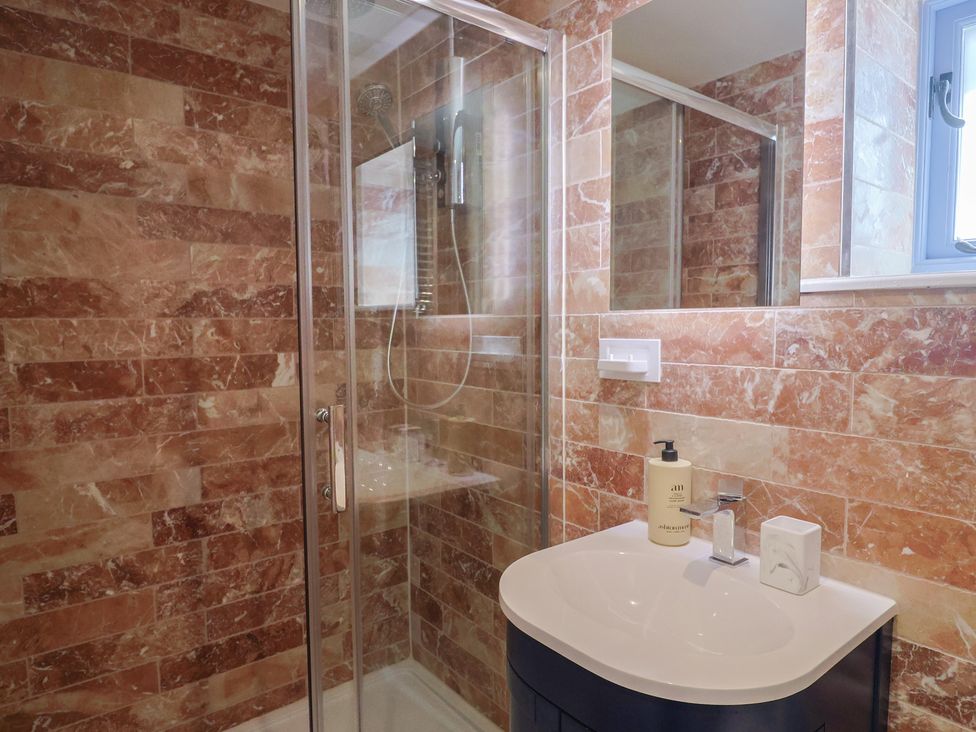 A bathroom with a shower and sink at Mayflower Cottage in Lyme Regis