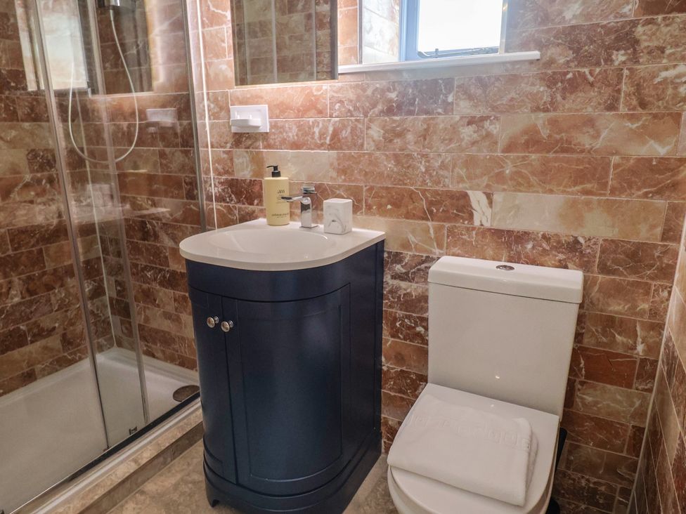 A bathroom with a shower, toilet, and sink at Mayflower Cottage in Lyme Regis