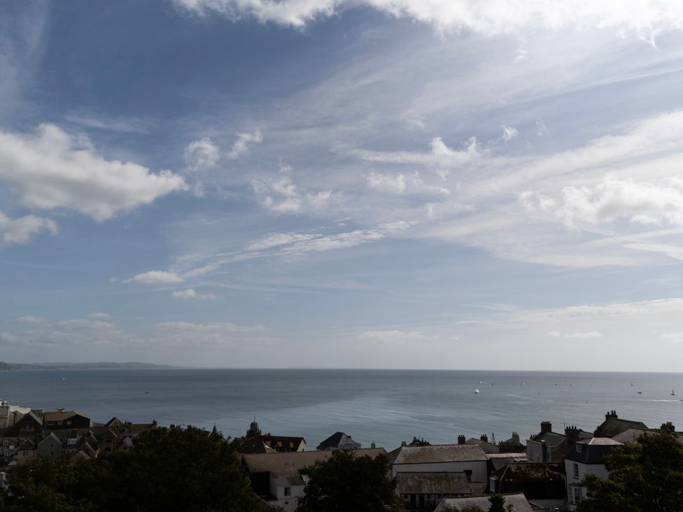 A view of the ocean and houses at Mayflower Cottage Lyme Regis