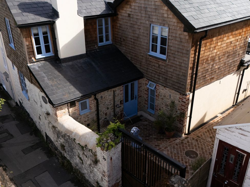 An exterior view of a house with a patio and garden at Mayflower Cottage Lyme Regis
