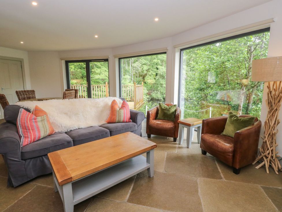 A living room with a sofa and armchairs at The Crannog in Killin