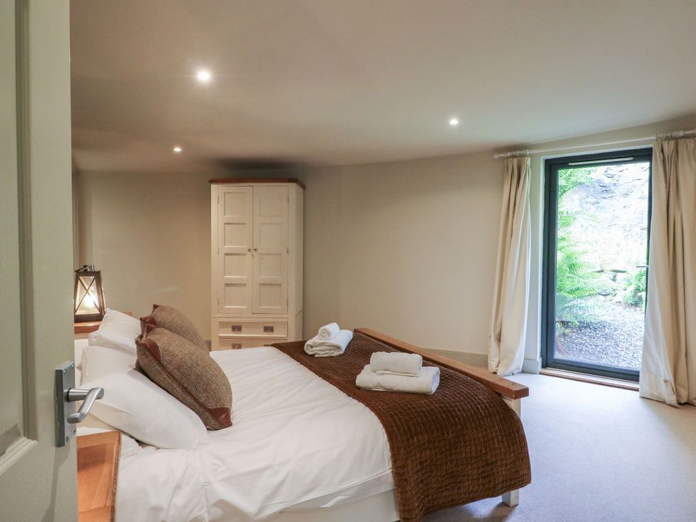 A bedroom with a bed and wardrobe at The Crannog in Killin