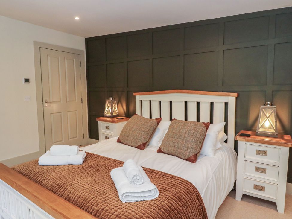A bedroom with a bed and bedside tables at The Crannog in Killin