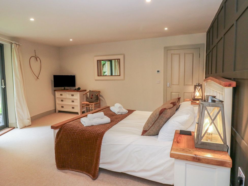 A bedroom with a bed and television at The Crannog in Killin