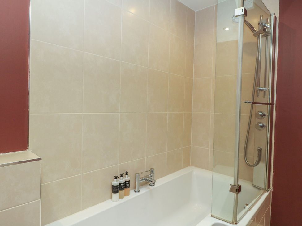 A bathroom with a bathtub and shower at The Crannog in Killin