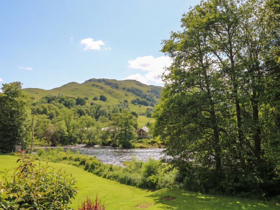 A scenic view of a river and hills at Riverbank Cottage in Killin