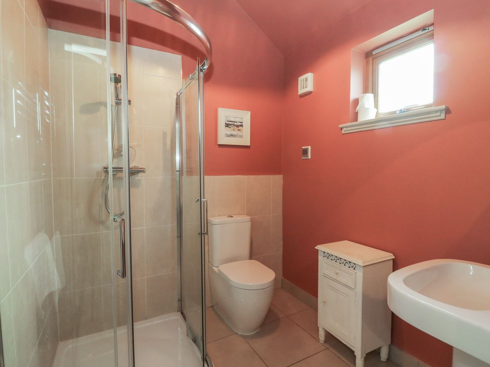 A bathroom with a shower and toilet at Riverbank Cottage in Killin