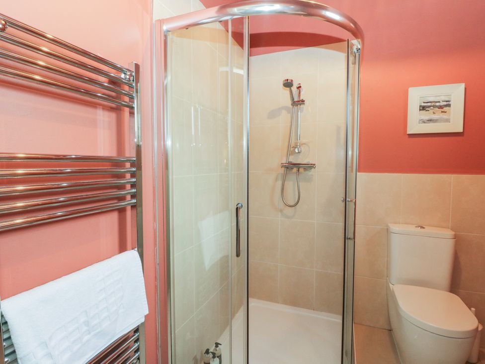 A bathroom with a shower and toilet at Riverbank Cottage in Killin