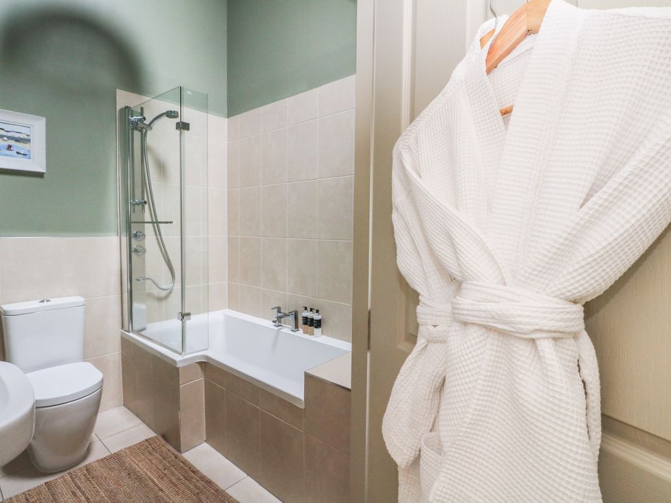 A bathroom with a bathtub and shower at Riverbank Cottage in Killin