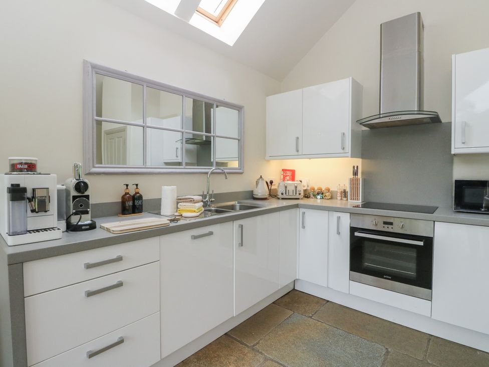 A kitchen with a coffee machine and kettle at Riverbank Cottage in Killin