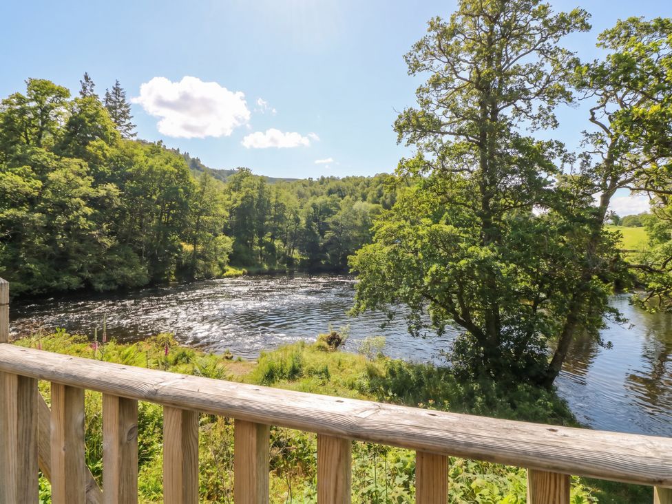 A view of a river surrounded by trees at Riverbank Cottage in Killin