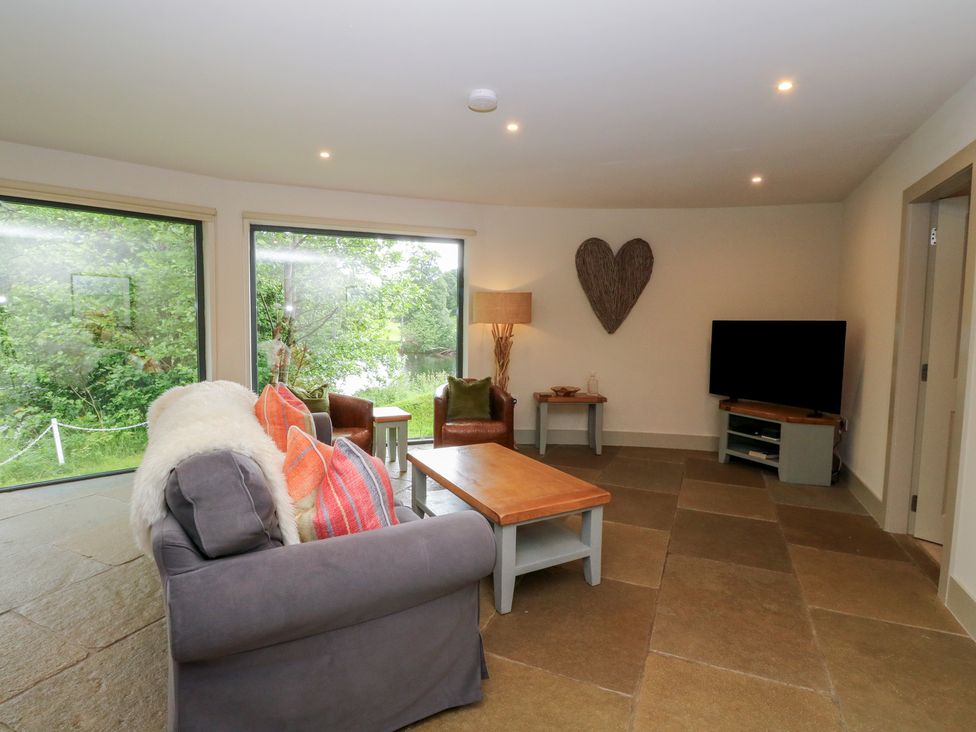A living room with a sofa and armchairs at Otter’s Holt in Killin