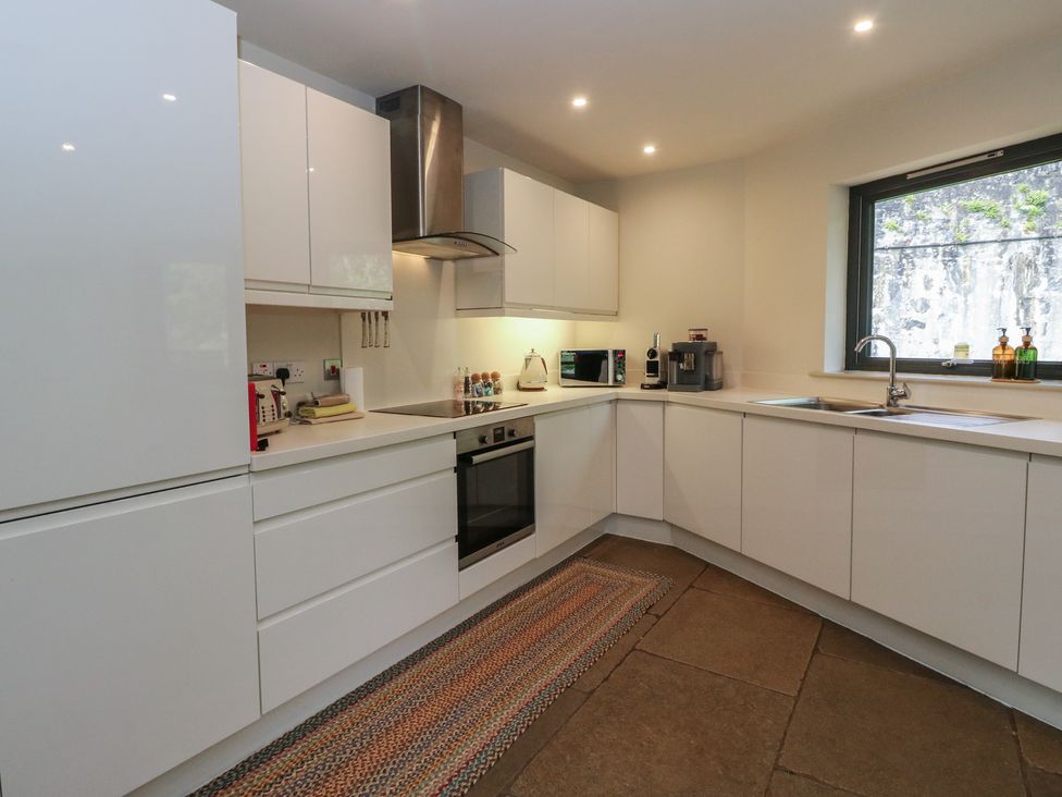 A kitchen with cabinets and appliances at Otter’s Holt in Killin