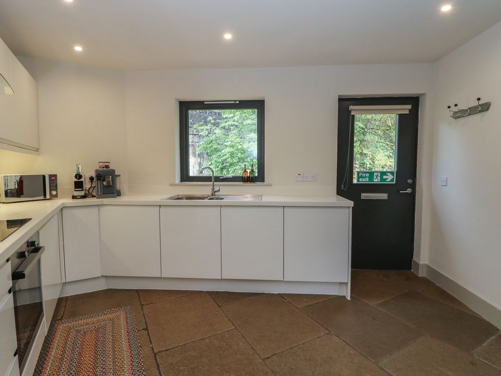 A kitchen with sink and appliances at Otter’s Holt in Killin