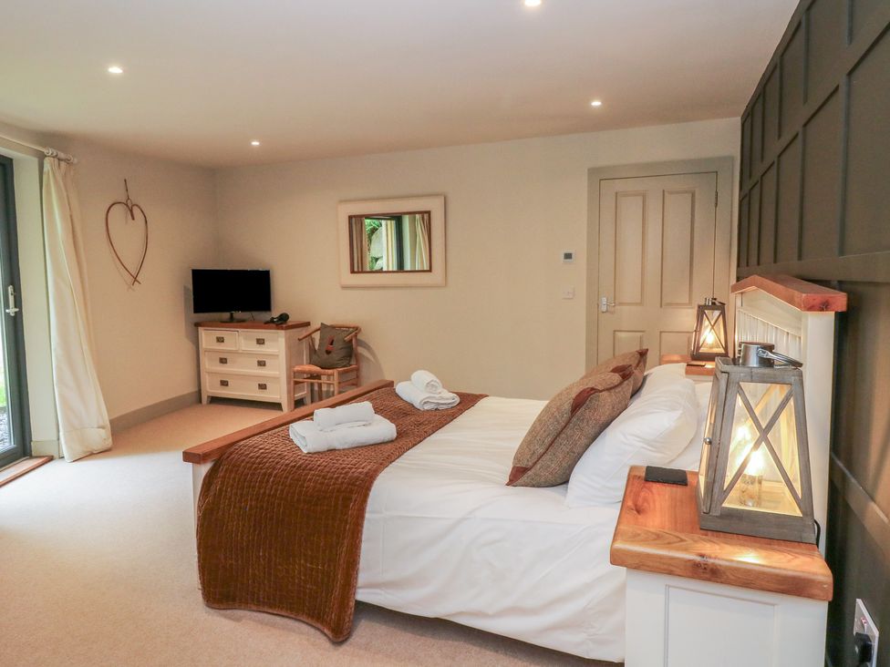 A bedroom with a bed and television at Otter’s Holt in Killin