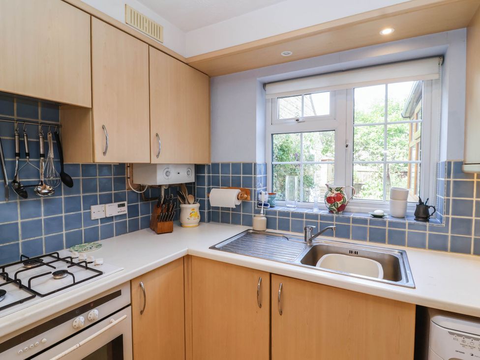 A kitchen with cabinets, sink, and window at Number 10, Broadway