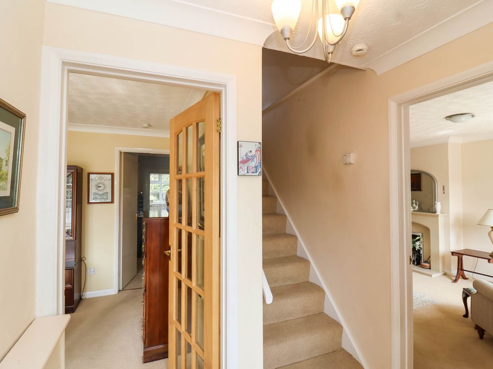 A hallway with a staircase and door at Number 10, Broadway