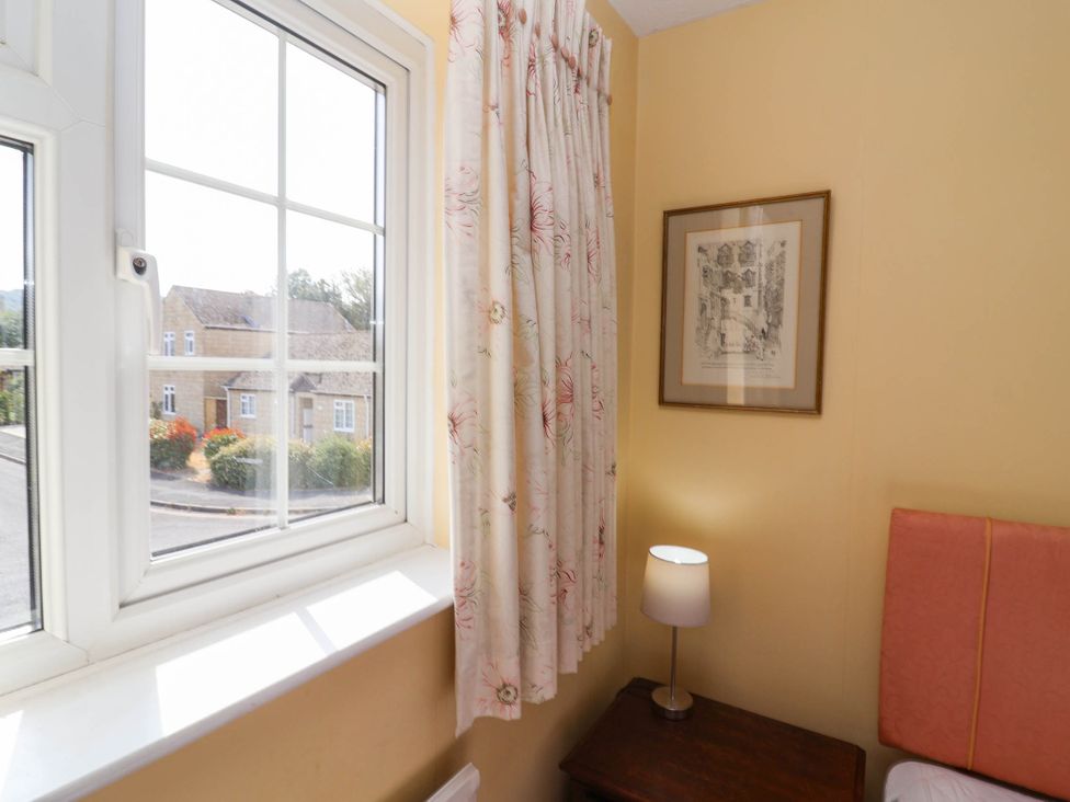 A bedroom with a window and a lamp at Number 10, Broadway