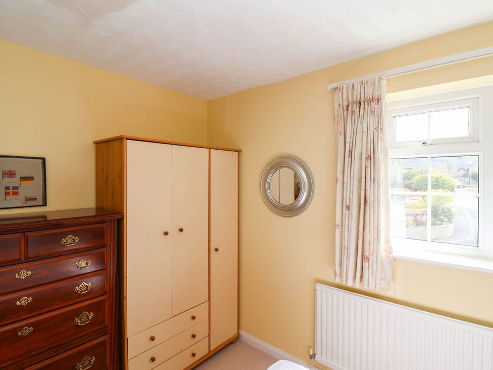 A bedroom with a wardrobe and chest of drawers at Number 10, Broadway