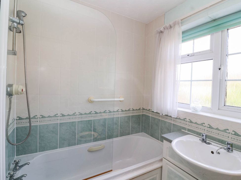 A bathroom with a bathtub and sink at Number 10, Broadway