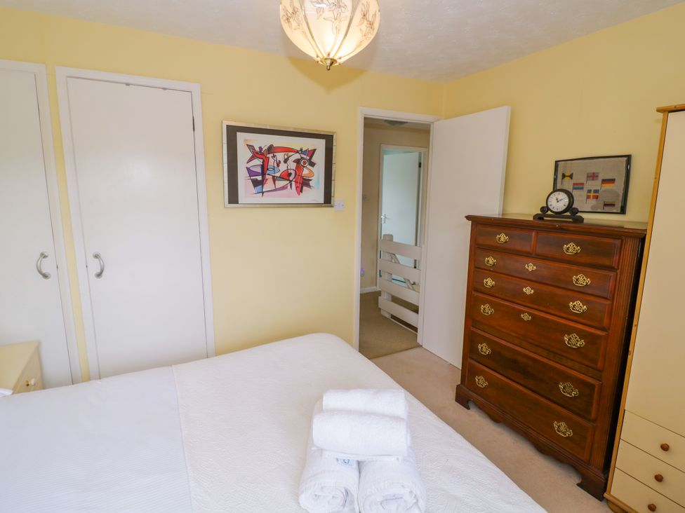A bedroom with a bed and a dresser at Number 10, Broadway