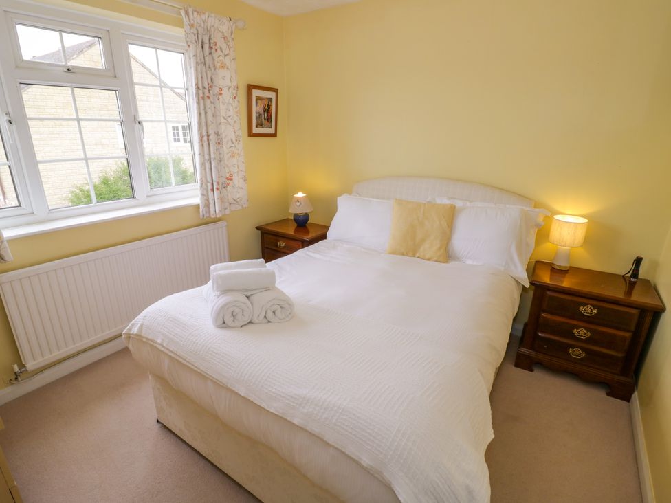 A bedroom with a double bed and bedside table at Number 10, Broadway