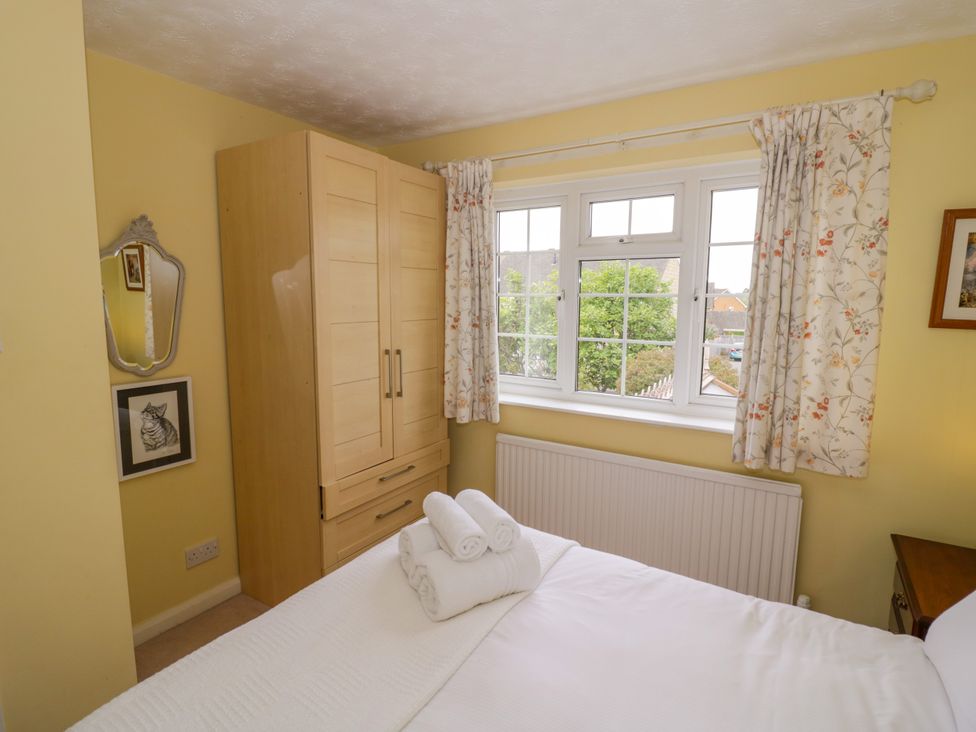 A bedroom with a bed and wardrobe at Number 10, Broadway