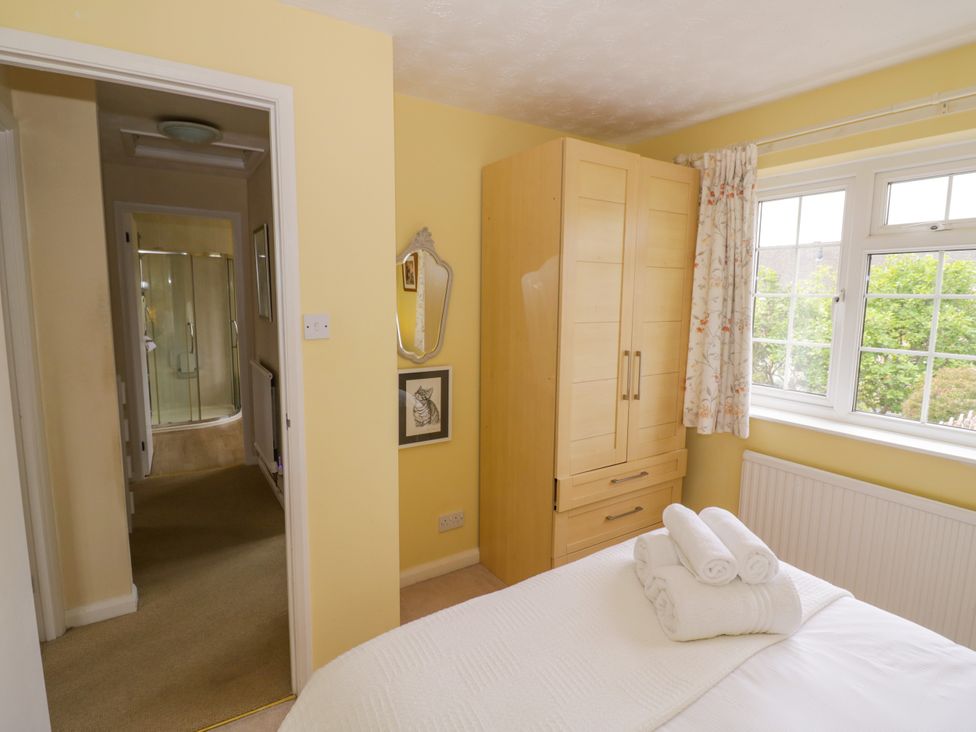 A bedroom with a bed and wardrobe at Number 10, Broadway