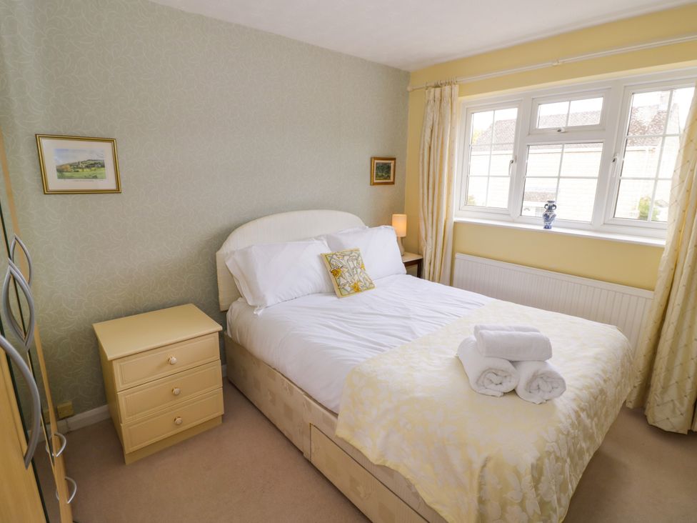 A bedroom with a double bed and window at Number 10, Broadway