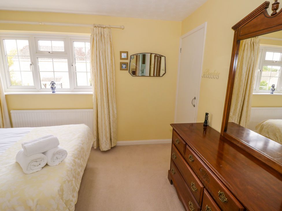 A bedroom with a bed and dresser at Number 10, Broadway