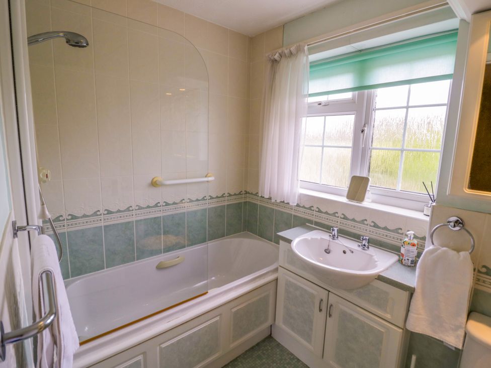 A bathroom with a bathtub and sink at Number 10, Broadway