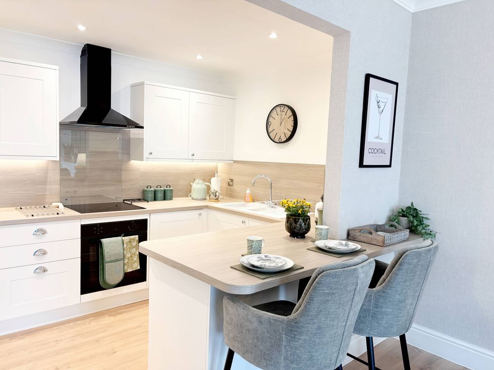 A kitchen with a stove and countertop at The Forbes in Torquay