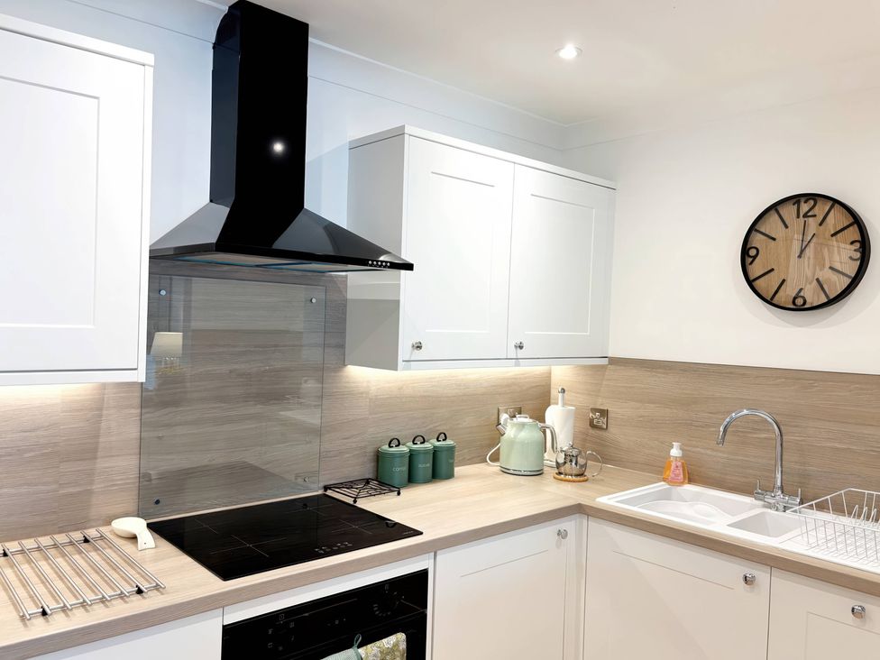 A kitchen with a sink and cooktop at The Forbes in Torquay